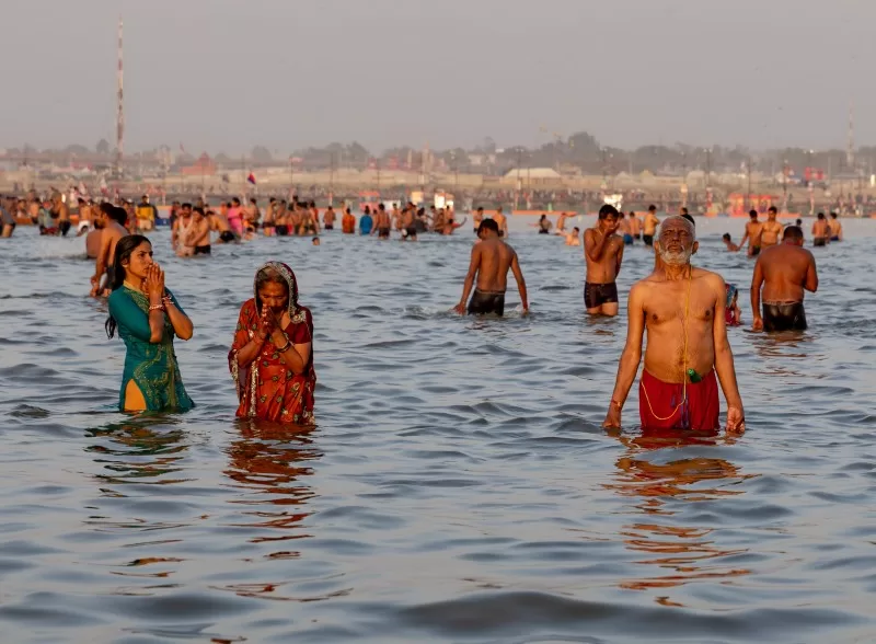 Pilgrims bathing in the river during the mela