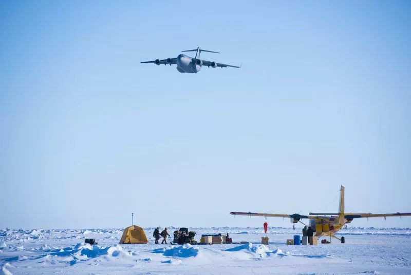 An airplane passes by a region in the North Pole