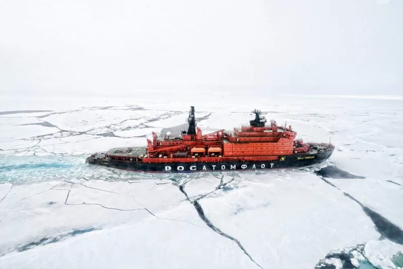An icebreaker cuts through the ice sheets in the North Pole