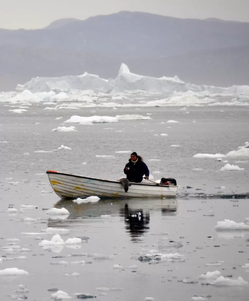 An Inuit man looks for seals in llulissat, Greenland