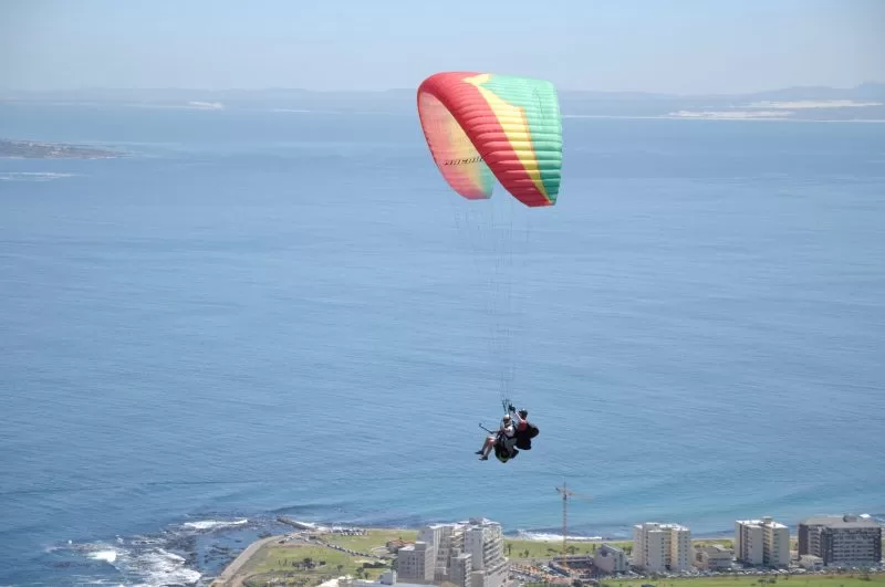 Tourists paragliding in Cape Town