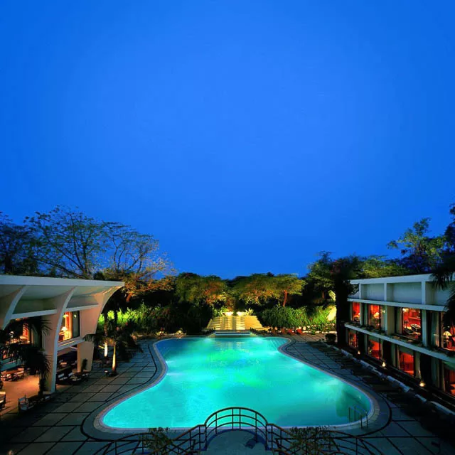 swimmimg pool lits up at night in the oberoi new delhi