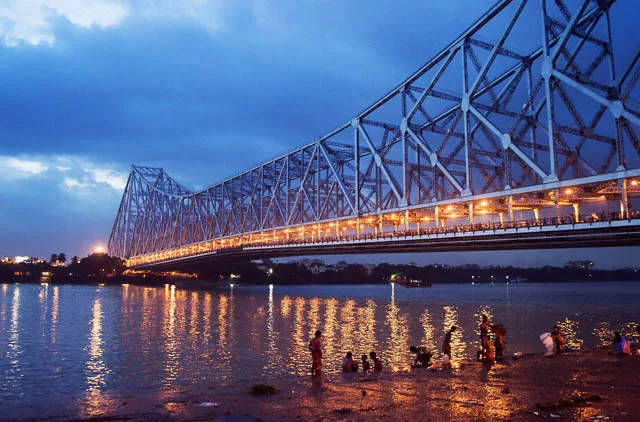 reflection of Howrah Bridge lights on Hoogly river in Kolkata, West Bengal