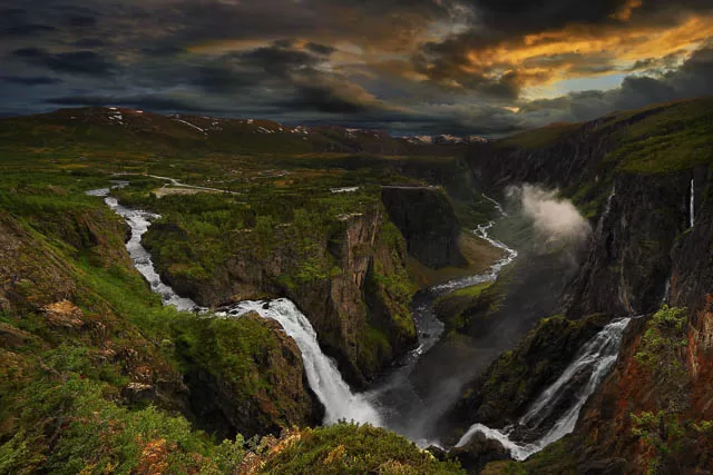 dark clouds over voringfossen waterfall in norway