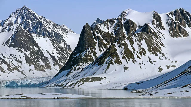 snow capped hills near magdalene fjord in svalbard, norway