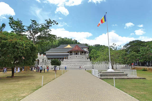 flag waving outside of temple of the sacred tooth relic in kandy, sri lanka