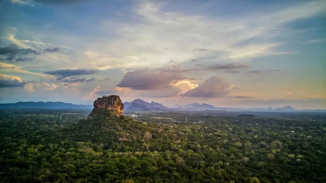 aerial view of the tropical forest with mountains at sunset over lion rock in sigiriya, sri lanka