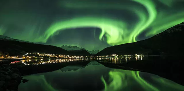 reflection of northern lights on a waterbody in narvik, norway