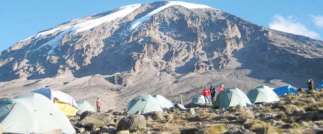 group of hikers camp climbing mount meru, tanzania