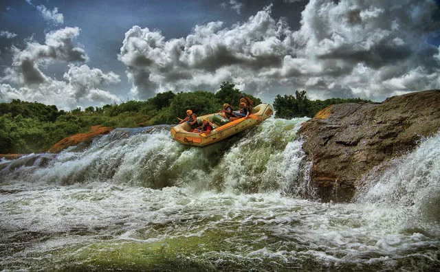tourists enjoys white water rafting on river nile in jinja, uganda