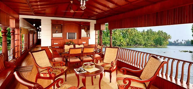 sitting area inside a houseboat overlooking the backwaters of kerala