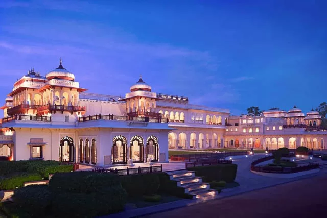 lights lit up at dusk in taj rambagh palace in jaipur, rajasthan