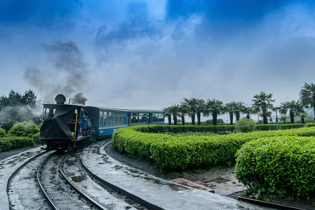 toy train blowing steam in darjeeling west bengal india