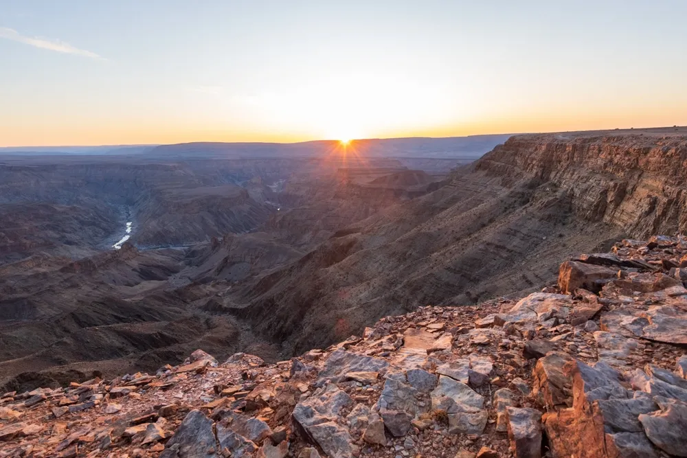 The vast switchbacks of the Fish River Canyon at sunset.