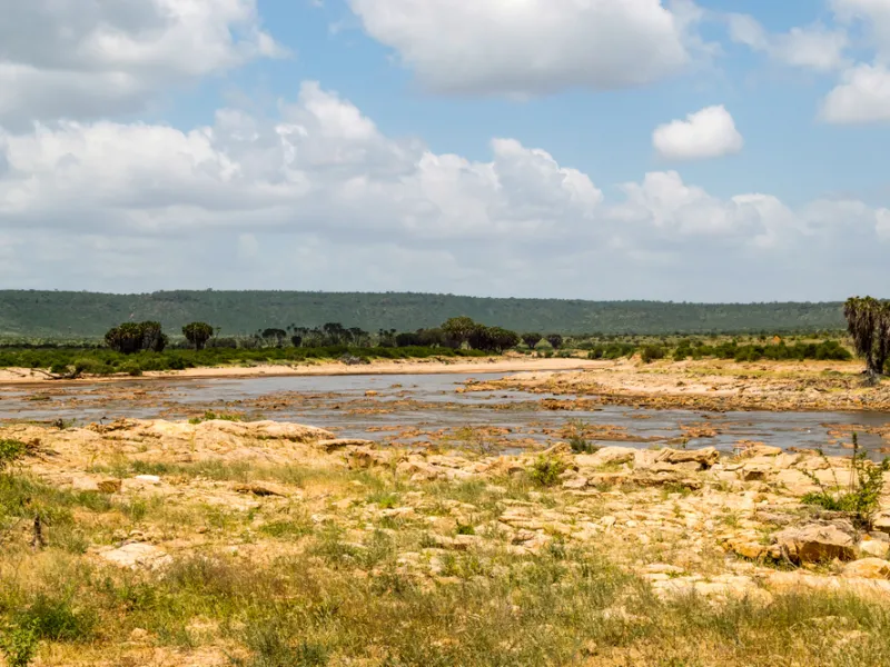 The Galana River cutting green through dry bush at Lugard Falls.