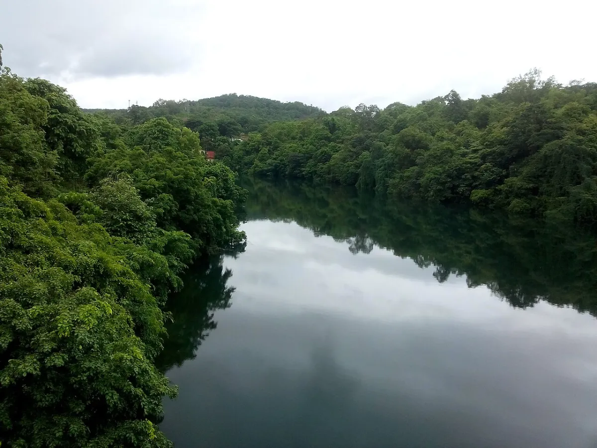 The Kali river running green through forested hills.